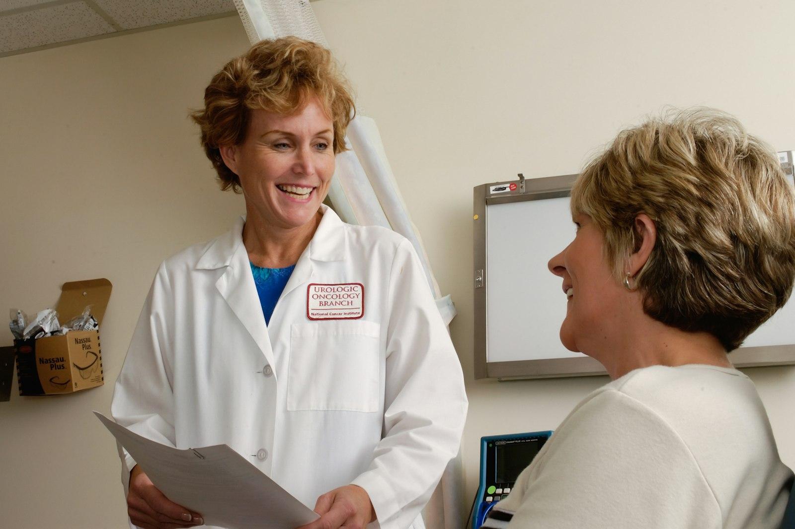 Senior compliance director reviewing customized safety binders with a practice manager in Oncology & Hospital Centers